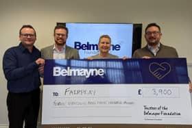 Belmayne's partners hand over the firm's donation to Heather Fawbert, chief executive of Fairplay.