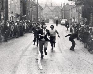 Brian Byard of Bank Road, Matlock, wins the Winster pancake race for the second year running in 1978.