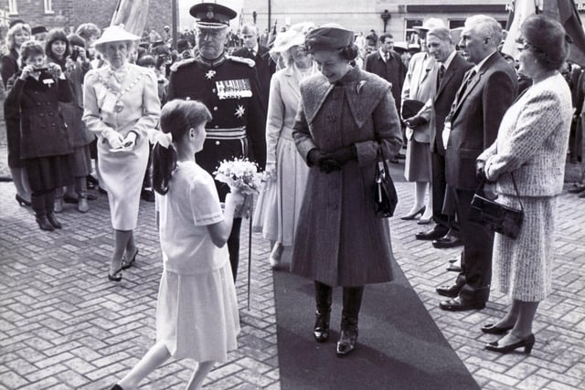 Corry Duggins, 10, presents flowers to Queen Elizabeth II  when she visited Underhall on a visit to  Darley Dale in 1985.