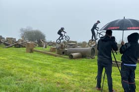 Owen Shipton is kept dry by Carl a Weightman as he films Oliver and Eddie Weightman for East Midlands Today