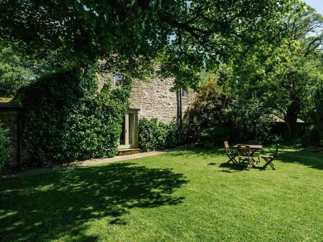 A lovely lawn offers space to sit and soak up the sunshine.