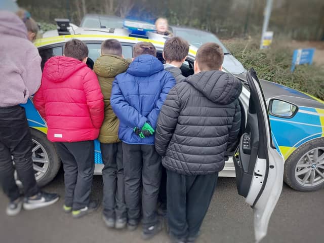 Shirebrook mini police inspect a police car. The mini police scheme launched in 2021 and is designed to give young children the opportunity to learn about their safety, their role within their community and how the police work to keep them safe.