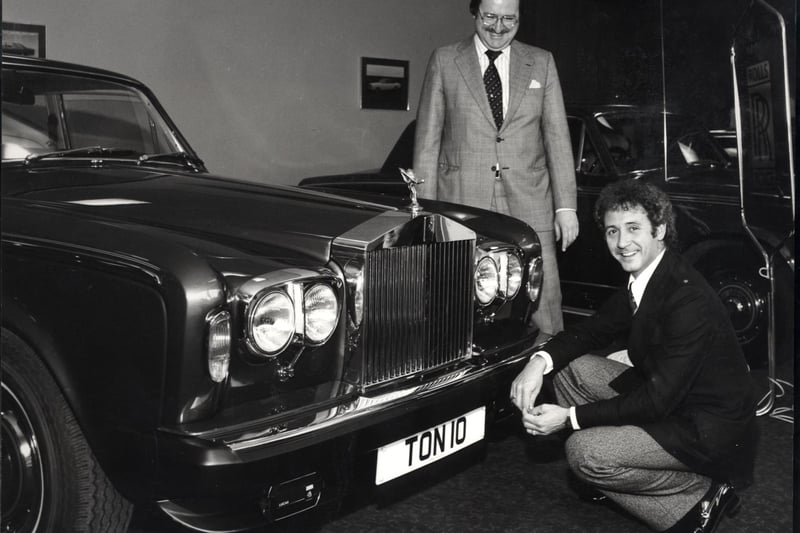 Tony Christie, knelt,  taking delivery of his new Rolls Royce silver shadow, June 1980.