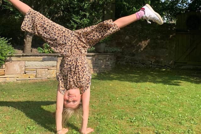 Lennie Taylor, seven, is cartwheeling her way to a Brownies badge for helping others.