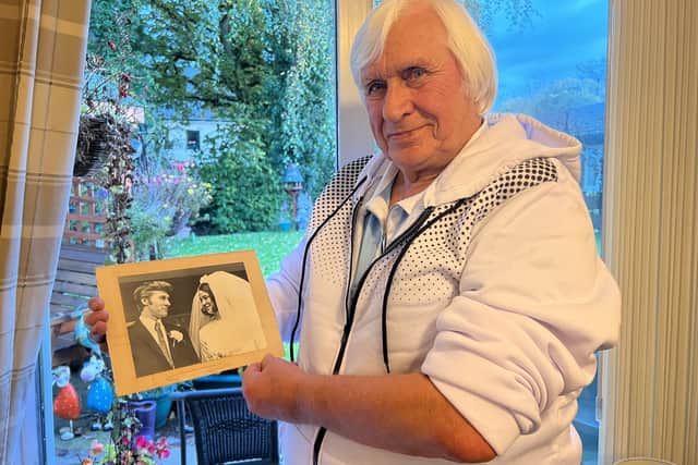 Mick Richmond with a photo of his wedding to Glennis, who spent her final days in Ashgate Hospice last December.