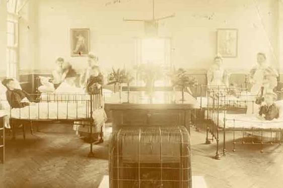This picture, from the early 1900s, shows staff looking after children on a ward - pictured from left to right are C. L. Edgington, Beatrice Hayes, Martha W. Foster and Elizabeth M. Davis.