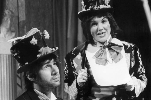 Gwen Taylor was born in Crich. She was an assistant area manager for the National Provincial Bank in Derby and became interested in amateur dramatics. Her first professional acting role was as a Green Bean in 'Jack and the Beanstalk' at the Derby Playhouse. Pictured here in 1976 with Neil Innes, musician, singer-songwriter and former member of the Bonzo Dog Doo-Dah Band, in 'Rutland Weekend Television' on BBC2.
