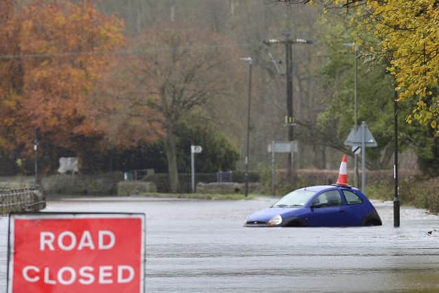 A swollen River Derwent floods a road in Darley Dale, Derbyshire.