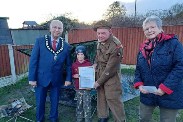 Pictured is Cllr Tom Munro, Martin and Cllr Mary Dooley presenting the certificate of achievement to Tommy (2nd from left)