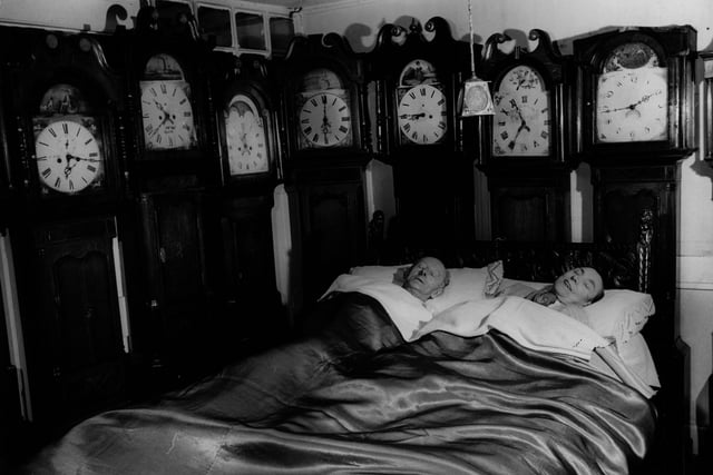 Mr and Mrs Charles Bromley of Belper at home with part of their collection of 109 grandfather clocks in 1955. (Photo by Ken Harding/BIPs/Getty Images)