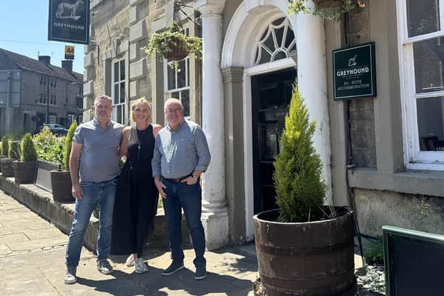 Greg and Sarah Dufton, with Mark Bromley, right, business development manager Admiral Taverns, outside The Greyhound at Cromford.