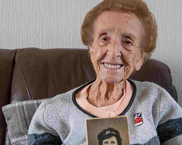 Margaret Wilson with a photo of herself when she served in the WAAF (photo: Richard Cannon)