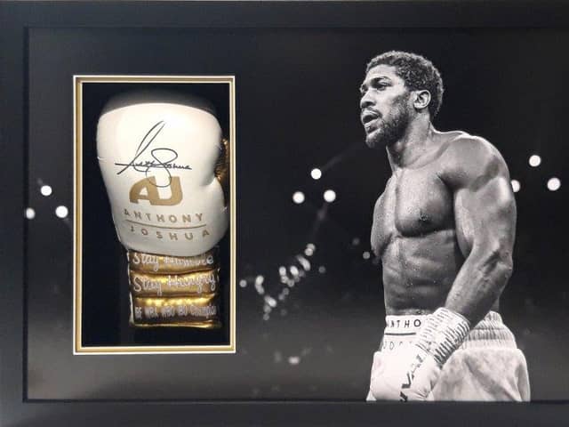 A boxing glove signed by Anthony Joshua is one of the lots.
