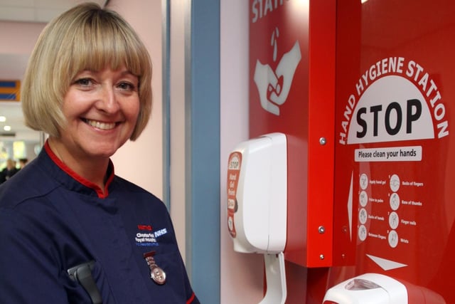 Lisa Bree, Infection Prevention and Control/TB Matron at Chesterfield Royal Hospital, demonstrating the hospital's new hand sanitiser posts.