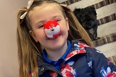Rosa, aged seven, dons a 'fox' red nose and colourful bows in her hair.