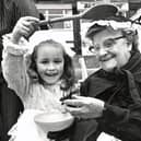 Little Miss Muffitt shows off her spider to one of the ladies from the Florence Shipley home at the Heanor Victorian market, 1983.