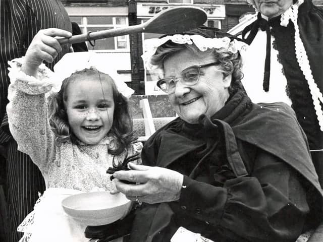 Little Miss Muffitt shows off her spider to one of the ladies from the Florence Shipley home at the Heanor Victorian market, 1983.