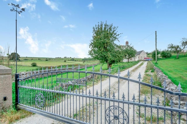 Broxendale farmhouse is set back from the road and has an impressive metal gate at the entrance to its driveway.