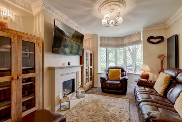 The sitting room has views of the park through the front bay window. A  remote controlled log effect gas fire with a limestone surround, mantel and hearth is a focal point in this cosy room.