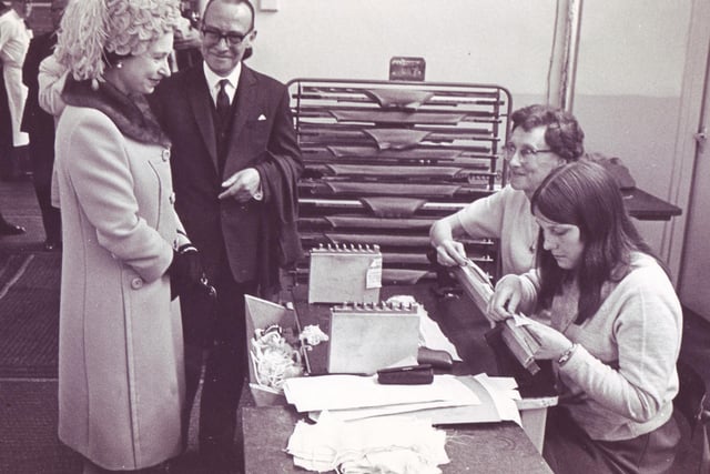 The Queen with managing director Mr W.T. Holder, talks with Minnie Parker (centre) and Susan Moore, during her tour of John Smedley Limited, Lea Mill, 1968.