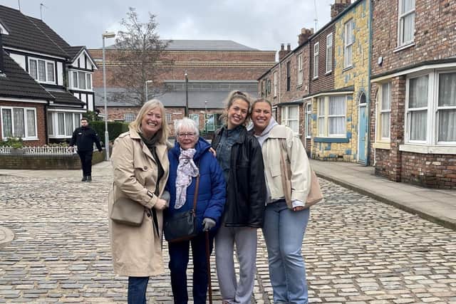Barbara Hopkinson with daughter Karen Cosier and granddaughters Mollie and Lauren Cosier on the Coronation Street TV set.  Photo: Mollie Cosier / SWNS