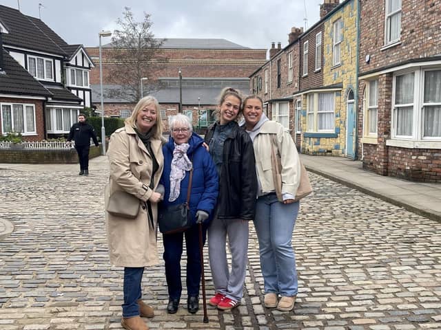 Barbara Hopkinson with daughter Karen Cosier and granddaughters Mollie and Lauren Cosier on the Coronation Street TV set.  Photo: Mollie Cosier / SWNS