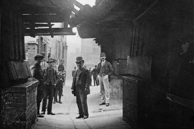 The Shambles, Chesterfield, in c1887. View showing the original wooden board 'fleshamols' (shelf flaps/window openings) of the butcher's shops. This street was named Shambles after the fleshamols on which butchers laid out their meat for sale in this area, in the 1400s.