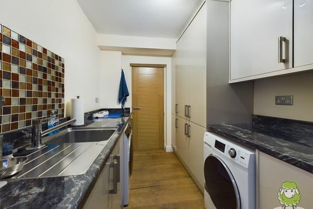Just off the kitchen is this very useful utility room, with storage, sink and space for a washing machine. It also has access to the property's tandem garage.