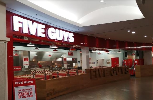 Sit in and enjoy made-to-order burgers, fries, hot dogs and free peanuts while you wait at Five Guys.