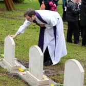 The Rev Andy Walker blessing the new headstones Pic Steve Ellis