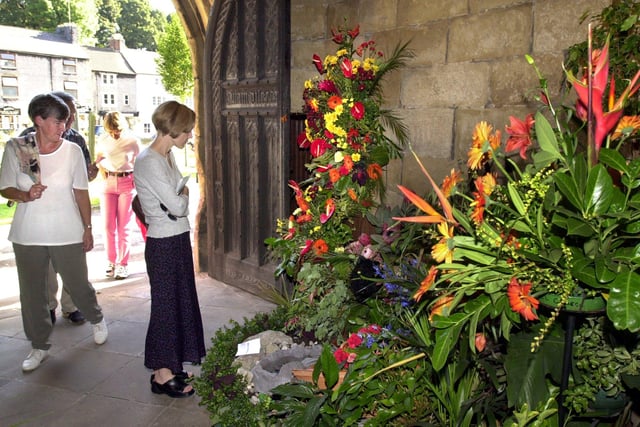 Visitors to 'The Cathedral of the Peak' The Parish Church of Tideswell Peak District enjoying the Jungle Book flower festival  in 2003