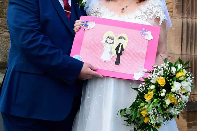 Mr and Mrs Vardy with the children’s card on their wedding day.