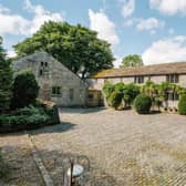 A farmhouse and two holiday let cottages are set within 5.25 acres of private grounds.