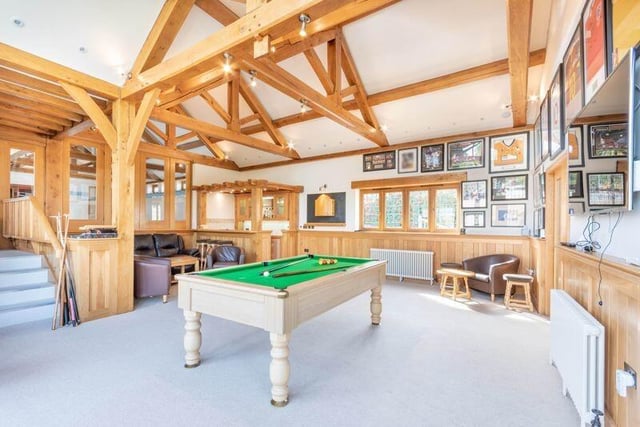 As we move into the stunning leisure complex within the Mansfield Road property, let's start in this magnificent, double-level entertainment and games room, which features a built-in bar.