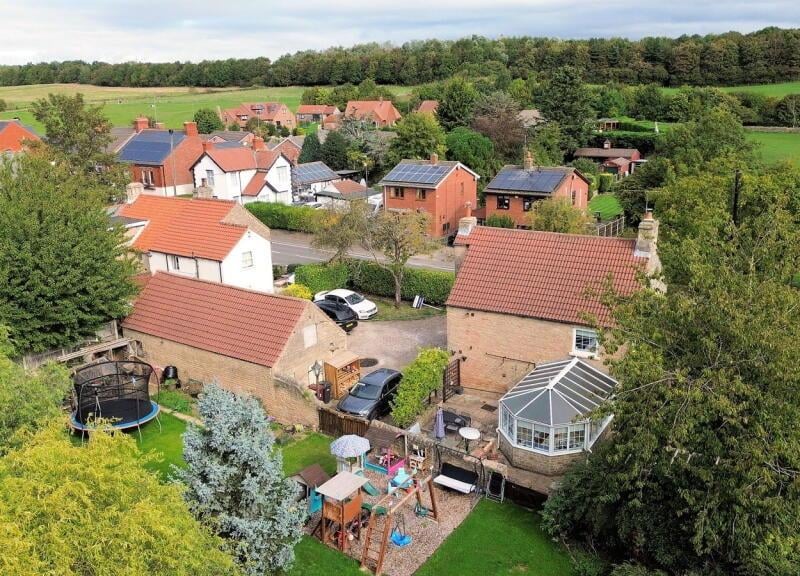 An aerial view of the cottage in its lovely location.