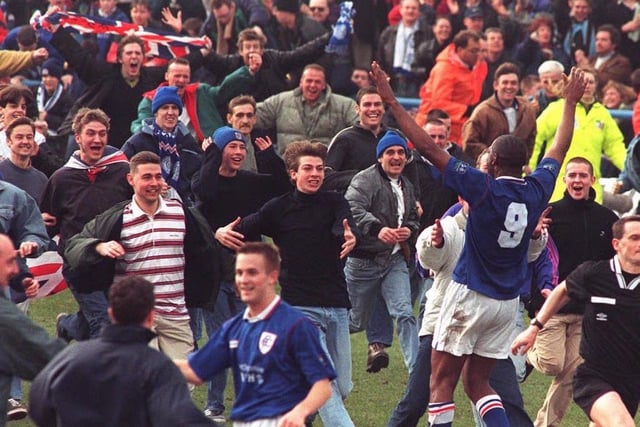 Chesterfield fans go wild as the final whistle blows and they defeat Wrexham for a place in the FA Cup Semi Finals in 1997, with Spireites player Andy Morris joining the party.