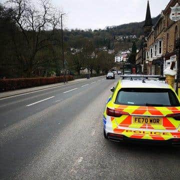 Police keep watch over the main road  through Matlock Bath