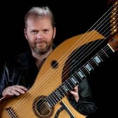 Jonathan Pickard with a harp-guitar which he has designed.