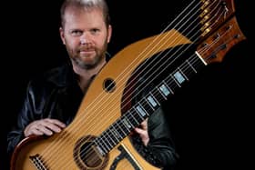 Jonathan Pickard with a harp-guitar which he has designed.