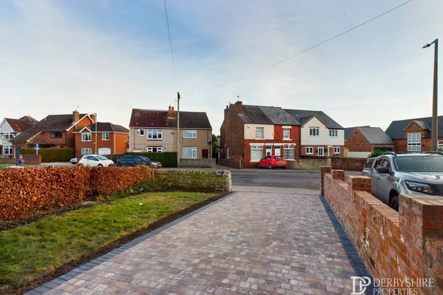 At the front of the £250,000 property, this spacious driveway provides plenty of space for off-street parking. Either side of the drive are a lawned garden with a hedged border, and a dry stone boundary wall.