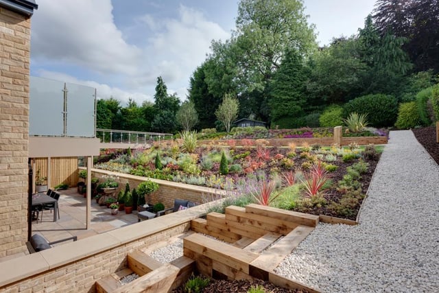 The communal gardens of the development are located at the rear and are mainly laid to lawn with exterior lighting, gravelled paths, mature trees and substantially stocked shrub borders. A suspended walkway with aluminium hand rails and balustrading leads to the first floor communal hall.