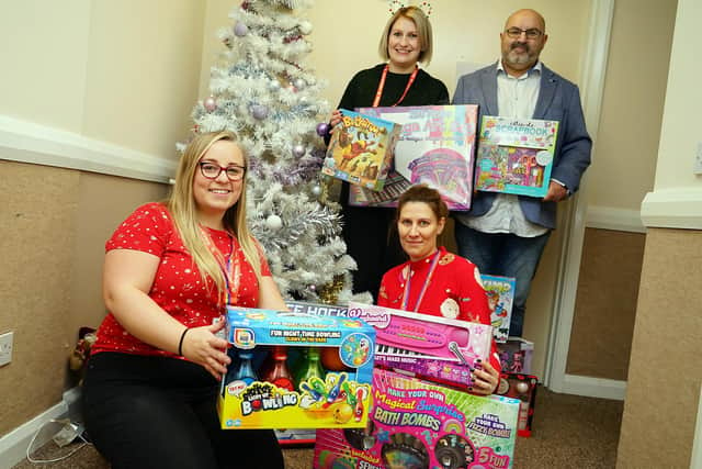 Sam Bannister seen handing over donated gifts and toileties to Action for Children on Queen Street Chesterfield. Back Laura Husselbee (family support worker), Sam Bannister, front, Emma Morgan (family support worker) and Michelle Pashley (senior volunteer co-ordinator)                      