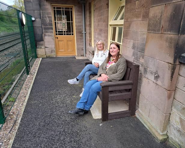 Debbie Hutchinson, left, and Jennie Dunn, on the bench which bears their father's name at Wingfield station. (Photo: Derbyshire Historic Buildings Trust)
