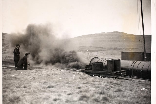 A controlled explosion at a mining safety research station at Harpur Hill, Derbyshire, where a handful of men were fighting continually against the causes of coal mine disasters. Coal dust, under certain conditions is as dangerous as high explosive and these men were experimenting every day to find an effective method of combating the menace. A four foot wide tube to represent a mine shaft was filled with coal dust and purposely exploded, then the burnt out dust known as firedamp, a very poisonous gas, was analysed. More deaths were caused by the gas than the actual explosion.  (Photo by Fox Photos/Hulton Archive/Getty Images)