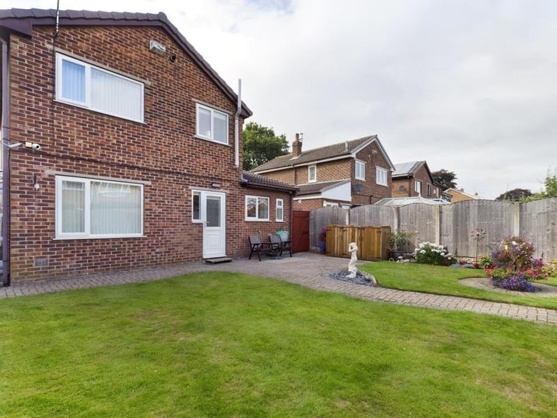 Rear garden - Fence enclosed, laid to lawn with block paved path and raised patio area, flower beds with a variety of plants, flowers and shrubs; timber garden shed, external lighting and garden tap.