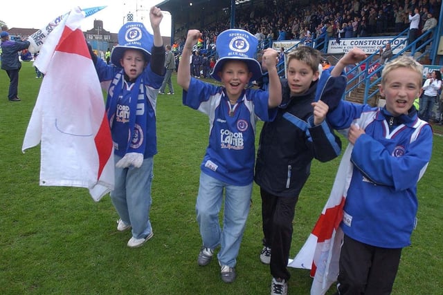 Chesterfield fans celebrate after their team escaped relegation against Luton Town.
