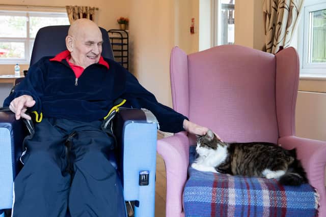 Bill Halstead with Milo, the resident cat at Presentation Sisters Care Centre in Matlock (photo: Lucy Ray/PA Wire).