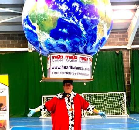 John Evans of Ilkeston balanced an 8ft globe weighed down with 7st of brick ballast on his head to claim his 103rd world record.