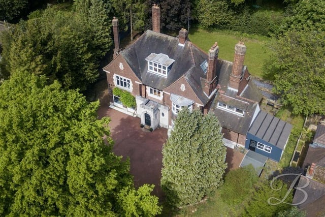 Before we step inside the Norfolk Drive mansion, let's take a look at an aerial shot from a drone. Private and secluded by mature trees, it sits on a plot spanning just under 0.6 acres.