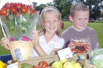 Children help out running the grocers stall at the Owsten Park Primary Summer Fayre in 2007.